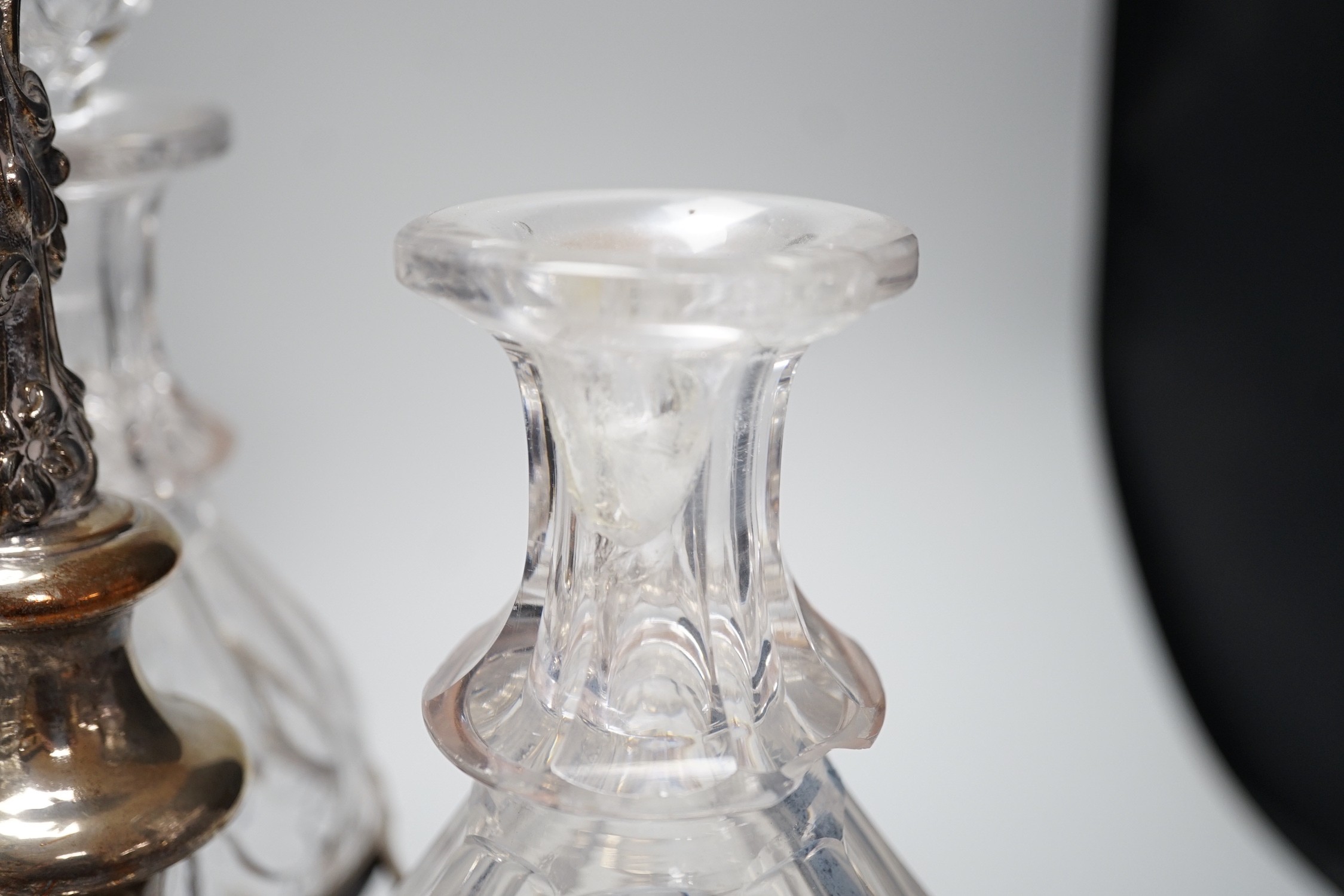 A decorative three bottle decanter set, on lion feet tripod plated stand. 37cm tall
